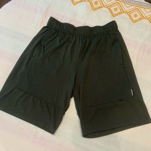 Dark green Gymshark shorts with zip pockets and drawstring